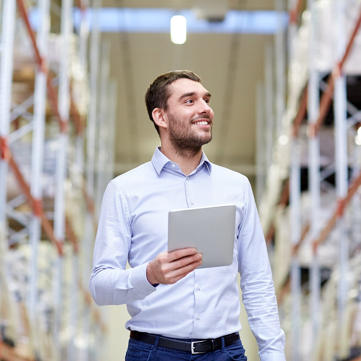 wholesale, logistic, business, export and people concept - happy man or manager with tablet pc computer checking goods at warehouse